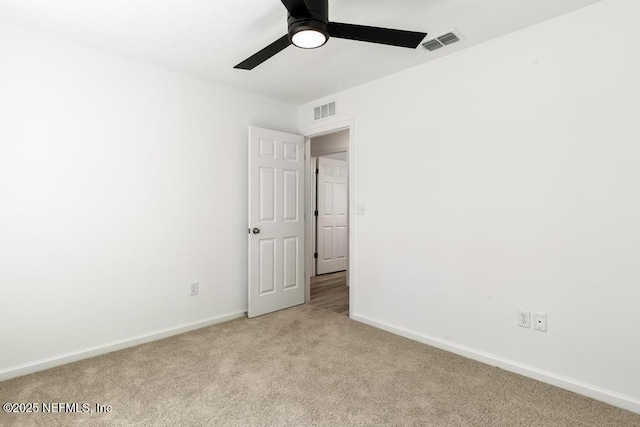 unfurnished bedroom with visible vents, a ceiling fan, baseboards, and light carpet