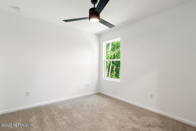 unfurnished room featuring baseboards, a ceiling fan, and carpet