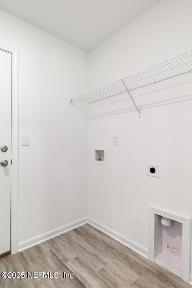 laundry area featuring laundry area, wood finished floors, hookup for a washing machine, baseboards, and electric dryer hookup