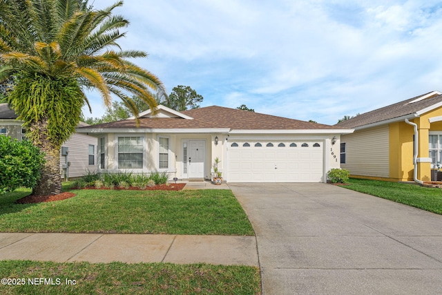 ranch-style house featuring driveway, an attached garage, a shingled roof, a front yard, and stucco siding