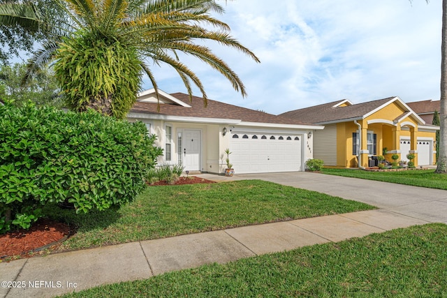 view of front of house featuring a garage, a front lawn, driveway, and stucco siding