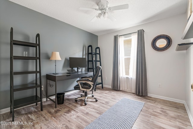 office featuring baseboards, wood finished floors, a textured ceiling, and ceiling fan