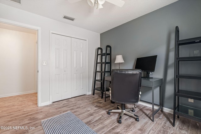 office area featuring baseboards, wood finished floors, and ceiling fan