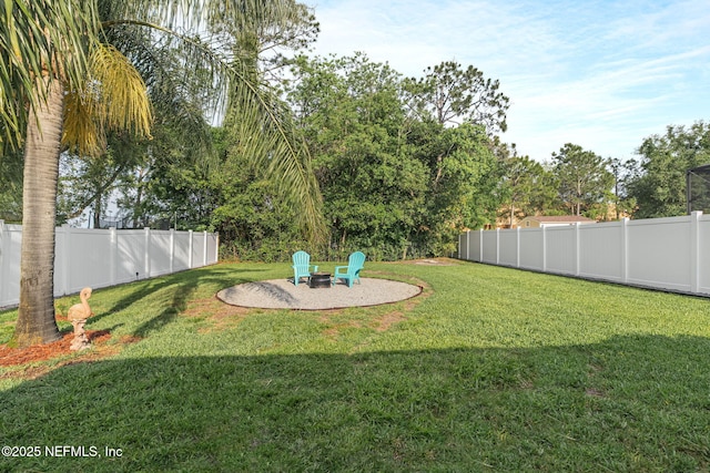 view of yard featuring a fenced backyard, a fire pit, and a patio