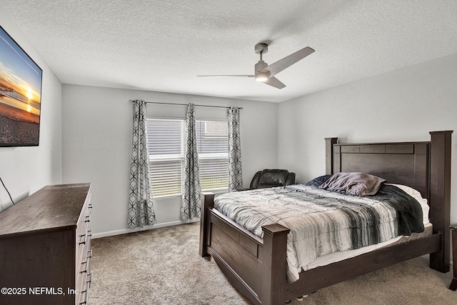 bedroom featuring carpet, a ceiling fan, baseboards, and a textured ceiling