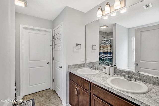 full bath featuring double vanity, visible vents, curtained shower, and a sink