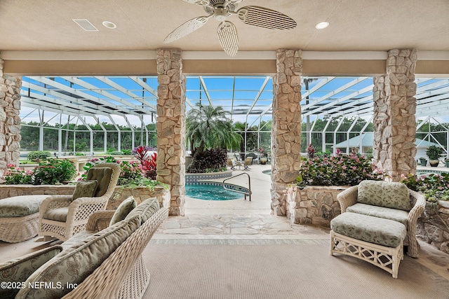 view of patio / terrace with a lanai, ceiling fan, and an outdoor pool
