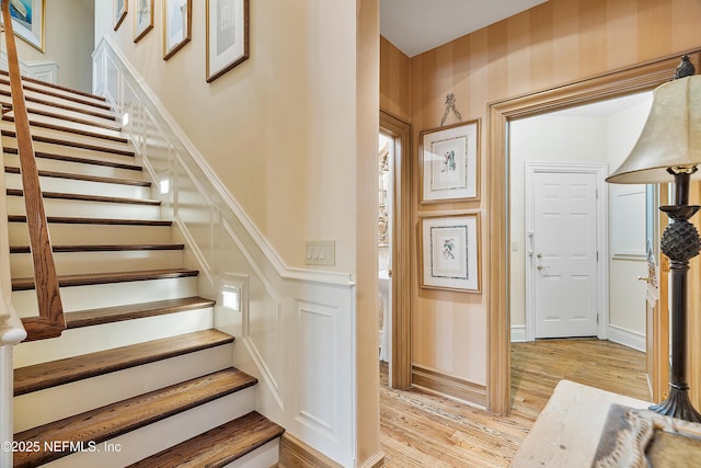 stairs featuring wood finished floors