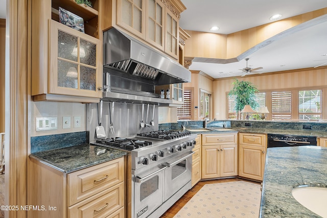 kitchen with double oven range, ventilation hood, light brown cabinets, a ceiling fan, and light wood-type flooring
