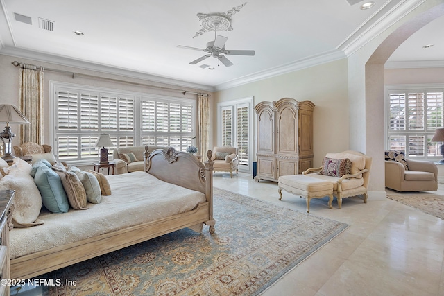 bedroom featuring arched walkways, multiple windows, crown molding, and a ceiling fan