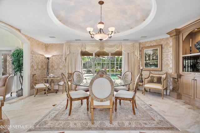 dining area featuring ornamental molding, a chandelier, light marble finish floors, wallpapered walls, and a raised ceiling