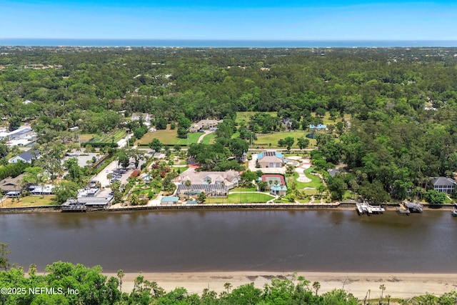 aerial view of a nearby body of water and a forest