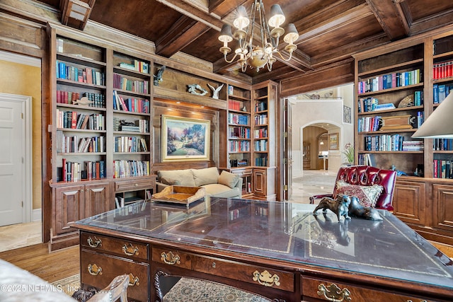home office featuring wood ceiling, arched walkways, built in features, coffered ceiling, and ornamental molding