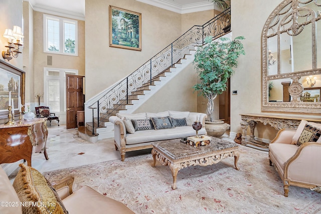 living area with a high ceiling, crown molding, and stairway