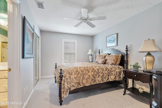carpeted bedroom featuring baseboards, ceiling fan, and a textured ceiling
