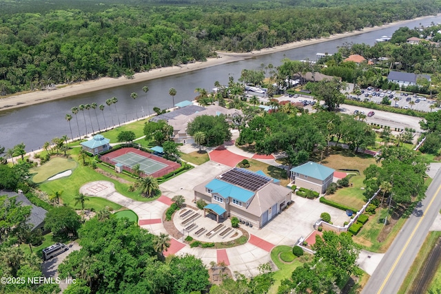 bird's eye view of a nearby body of water and a heavily wooded area