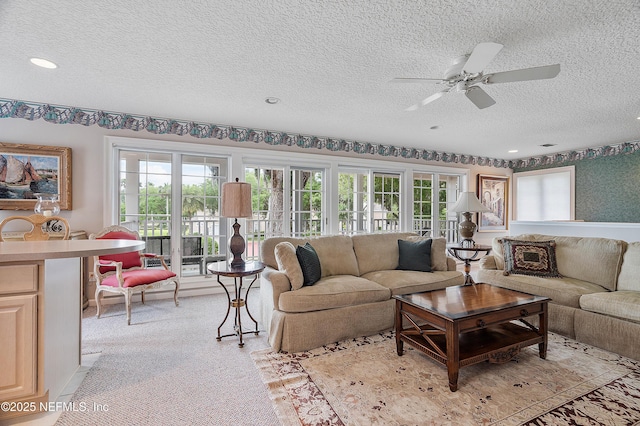 living room with a textured ceiling, healthy amount of natural light, a ceiling fan, and recessed lighting