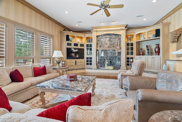 living room featuring ornamental molding, ceiling fan, wood finished floors, a fireplace, and recessed lighting