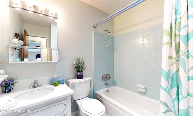 full bathroom featuring vanity, shower / bath combo with shower curtain, and toilet