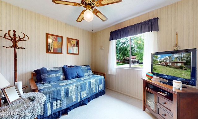 carpeted bedroom with a ceiling fan and wallpapered walls