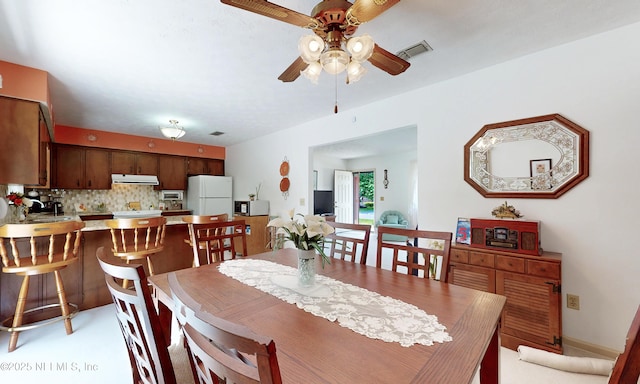 dining area with a ceiling fan and visible vents