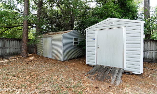 view of shed with fence