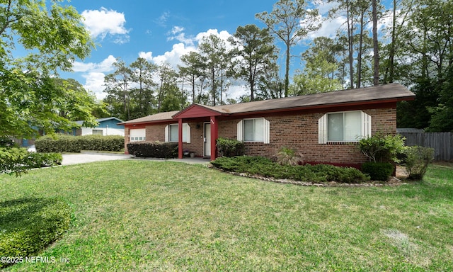 single story home with fence, a front yard, and brick siding