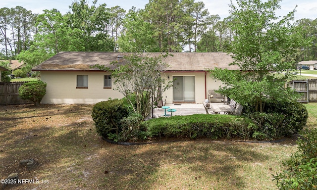 back of property featuring a patio area, fence, and roof with shingles