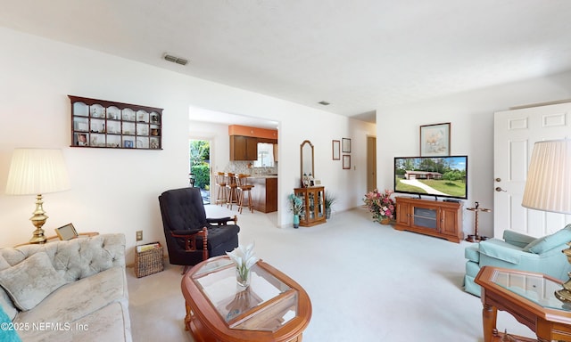 carpeted living room featuring visible vents