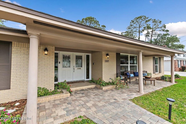 2327 Cheryl Dr, Jacksonville, FL 32217 - doorway to property with brick siding and a porch