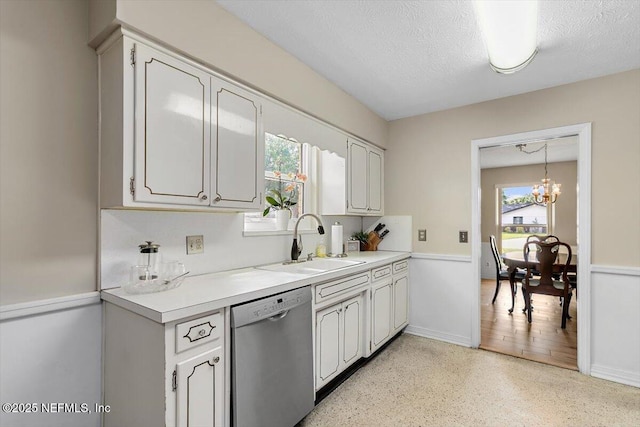 2327 Cheryl Dr, Jacksonville, FL 32217 - kitchen with stainless steel dishwasher, a sink, light countertops, a chandelier, and dark aggregate flooring
