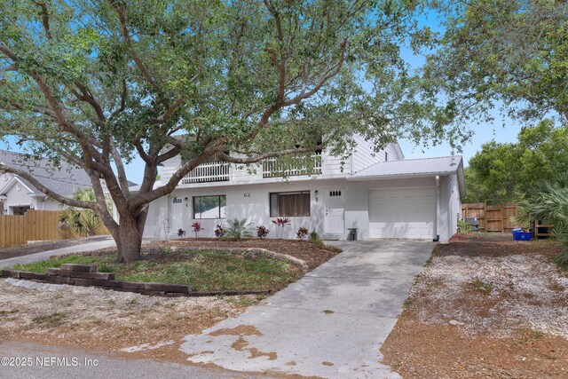 62 Atlantic Oaks Cir, Saint Augustine, FL 32080 - view of front of house featuring fence, driveway, metal roof, and a garage
