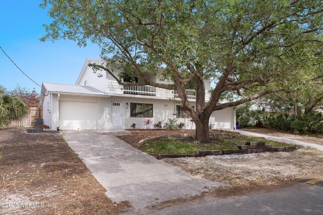62 Atlantic Oaks Cir, Saint Augustine, FL 32080 - view of front of property with driveway, cooling unit, a balcony, metal roof, and an attached garage