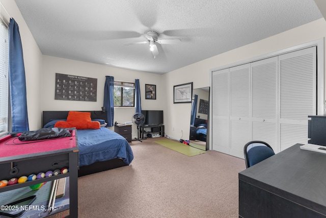 62 Atlantic Oaks Cir, Saint Augustine, FL 32080 - bedroom with a closet, ceiling fan, carpet floors, and a textured ceiling