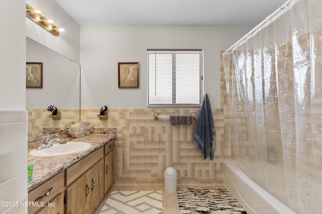 62 Atlantic Oaks Cir, Saint Augustine, FL 32080 - full bath featuring tile walls, vanity, shower / bath combo with shower curtain, a wainscoted wall, and tile patterned flooring