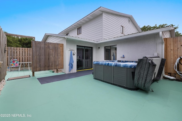 62 Atlantic Oaks Cir, Saint Augustine, FL 32080 - rear view of house with fence, a patio area, stucco siding, and a hot tub