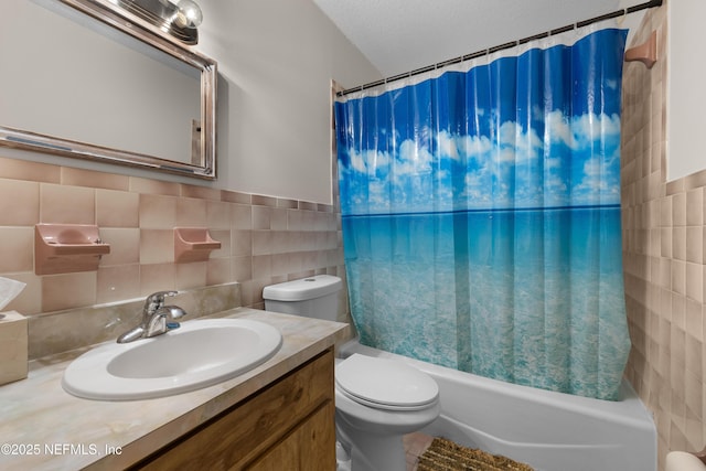 62 Atlantic Oaks Cir, Saint Augustine, FL 32080 - bathroom featuring a textured ceiling, toilet, tile walls, shower / bathtub combination with curtain, and vanity