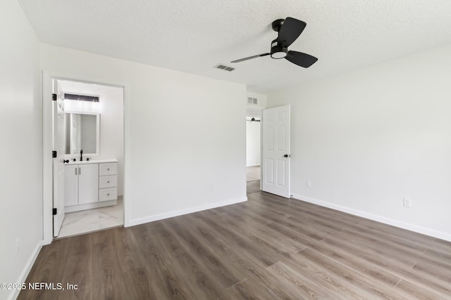 7843 India Ave, Jacksonville, FL 32211 - unfurnished bedroom with a textured ceiling, baseboards, wood finished floors, and visible vents