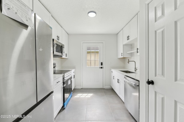 7843 India Ave, Jacksonville, FL 32211 - kitchen with a sink, light countertops, a textured ceiling, stainless steel appliances, and light tile patterned floors