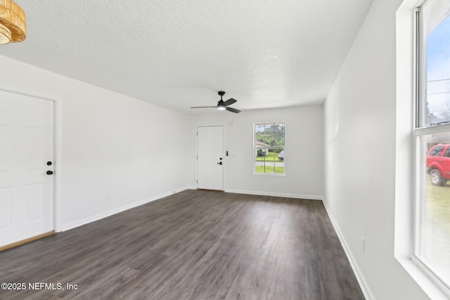 7843 India Ave, Jacksonville, FL 32211 - unfurnished living room featuring baseboards, ceiling fan, a textured ceiling, and dark wood-type flooring
