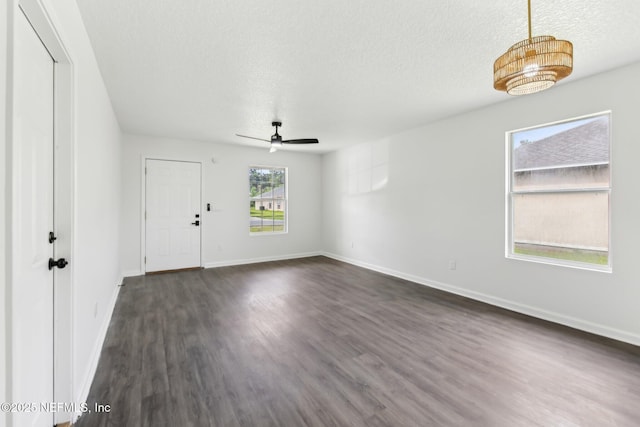 7843 India Ave, Jacksonville, FL 32211 - interior space with a ceiling fan, a textured ceiling, baseboards, and dark wood-type flooring
