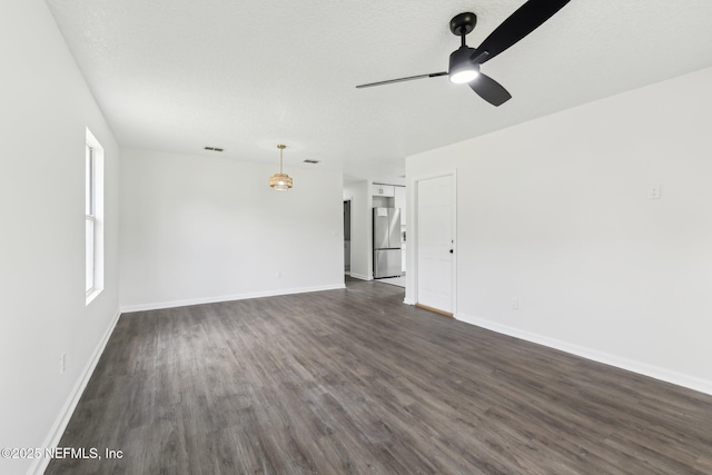 7843 India Ave, Jacksonville, FL 32211 - unfurnished living room featuring baseboards, a ceiling fan, dark wood-style floors, and visible vents