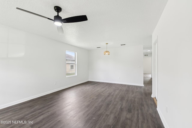7843 India Ave, Jacksonville, FL 32211 - empty room with ceiling fan, dark wood-style flooring, a textured ceiling, visible vents, and baseboards