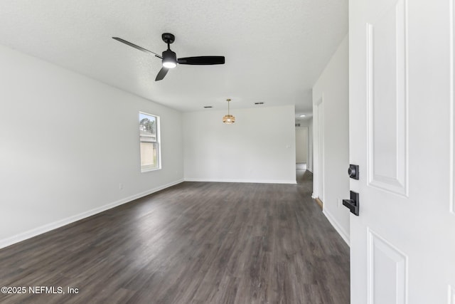 7843 India Ave, Jacksonville, FL 32211 - empty room featuring baseboards, a ceiling fan, a textured ceiling, and dark wood-style floors