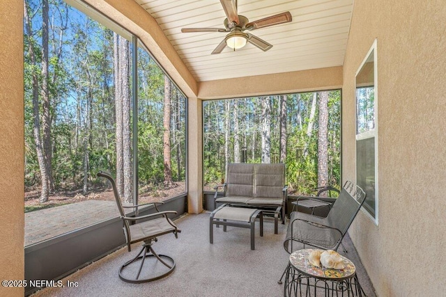 sunroom / solarium featuring a ceiling fan