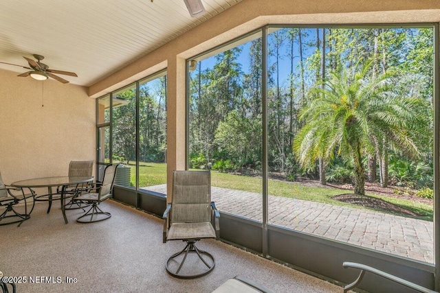 sunroom / solarium featuring ceiling fan