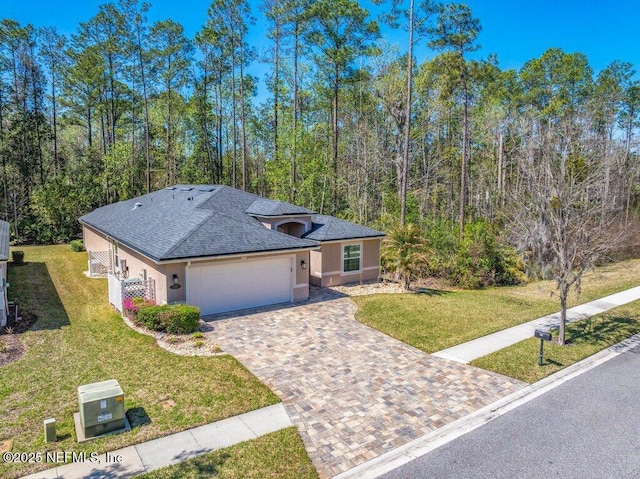 ranch-style home featuring a garage, stucco siding, a shingled roof, and a front lawn