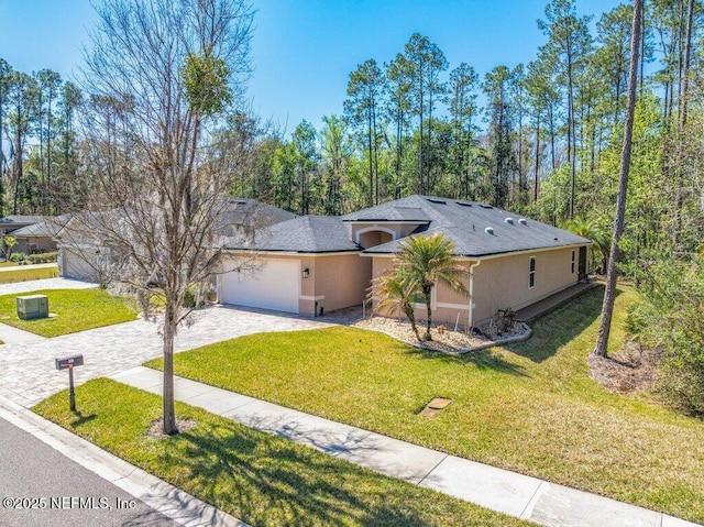 single story home featuring stucco siding, driveway, a front lawn, and a garage