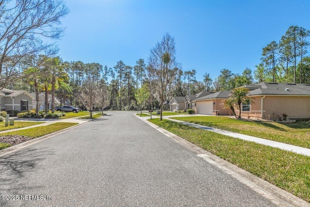 view of street with a residential view, sidewalks, and curbs