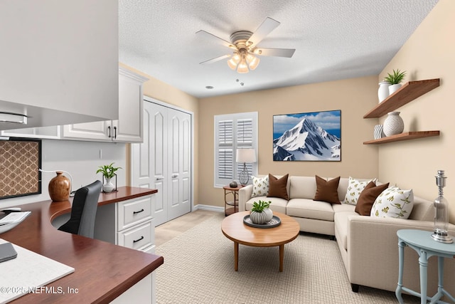 office with a ceiling fan and a textured ceiling